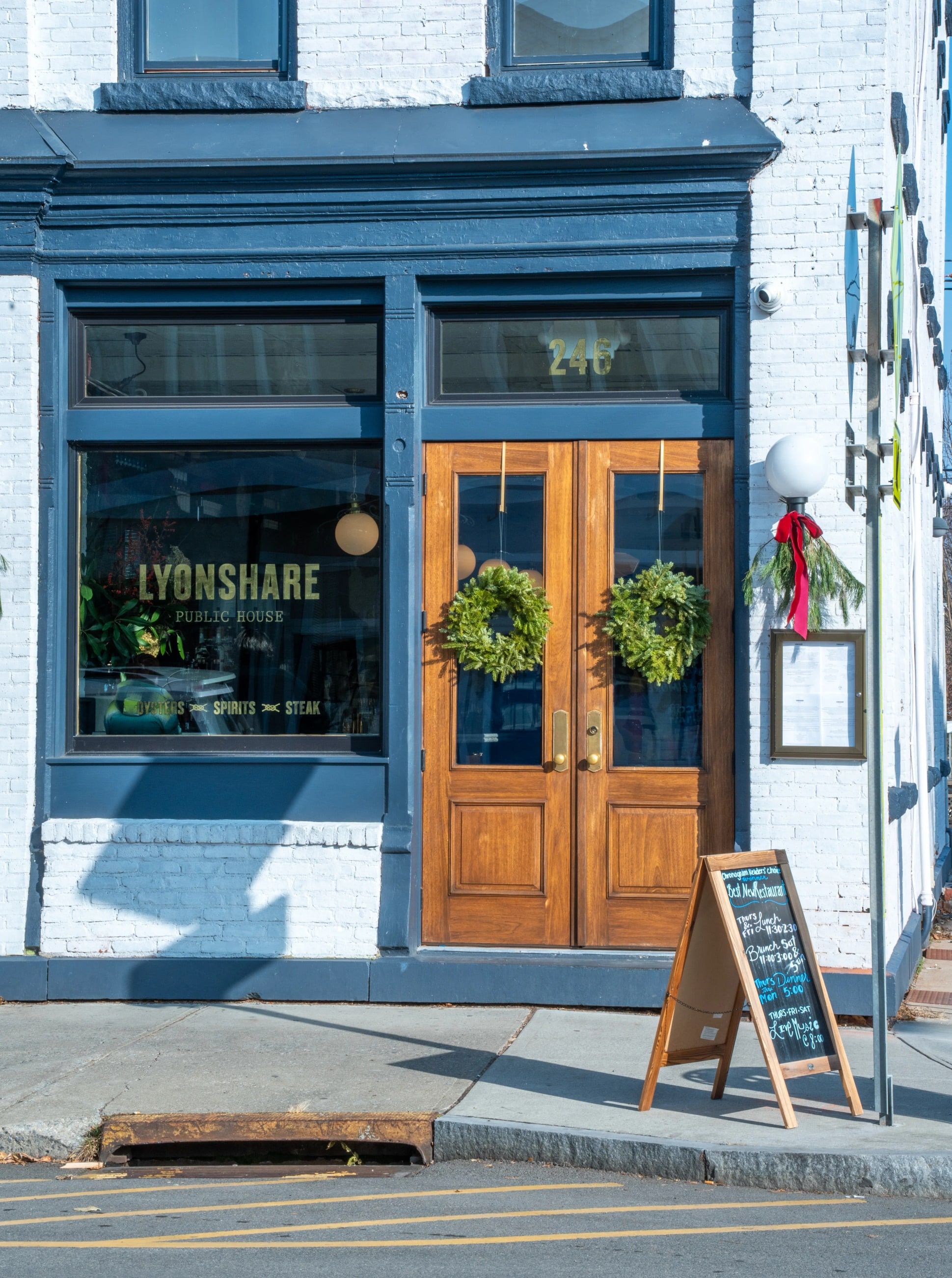 Lyonshare’s storefront on Main Street: whitewashed brick, navy trim and wooden double doors.